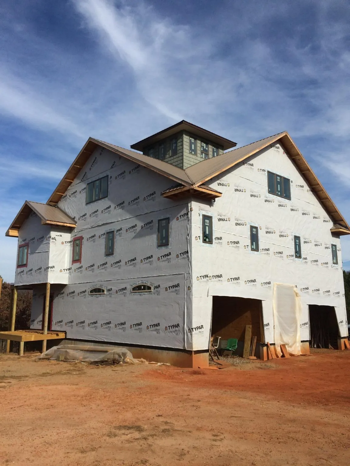 New two story house under construction with a cupola and gabled roofs in Avonmore